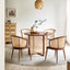 Modern solid wood dining set with natural rattan accents.