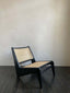 Black wooden lounge chair with woven cane seat and backrest