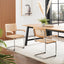 Pair of oak and rattan cantilever chairs with chrome frames against white wall