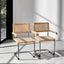Pair of oak and rattan cantilever chairs with chrome frames against white wall