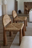 Modern rustic chair with natural wood and seaweed details.